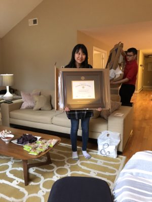 Lab member holding up framed paper award
